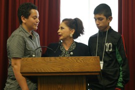 The Rev. Eve Nunez from Arizona speaks in Washington with two unidentified young men whose families have been disrupted by deportation, a situation Nunez said she has to deal with often among her parishioners.