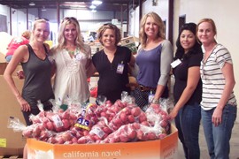 Harrison Farm representatives pose with donated food at the Yuma Community Food Bank. Harrison Farms is one of many farms in the Yuma area that donates fresh produce to the food bank.