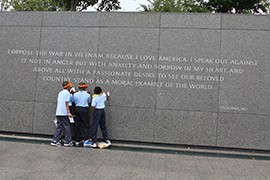 Sixth-grade students from Cora L. Rice Elementary School in nearby Landover, Md., copy a quote inscribed in the wall at the Martin Luther King Jr. Memorial on the 50th anniversary of the March on Washington.