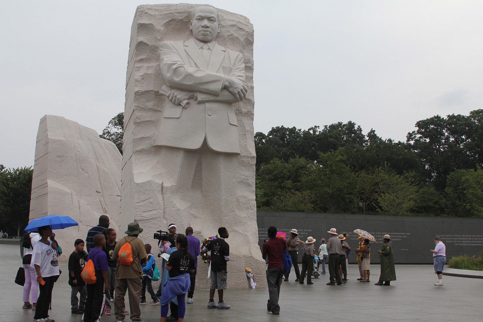 A group of visitors from New York gathers at the Martin Luther King Jr. Memorial on the 50th anniversary of King's historic March on Washington, which was being celebrated nearby on the Mall.