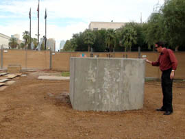 Secretary of State Ken Bennett examines one of two concrete pedestals that will hold refurbished gun barrels from the USS Arizona and USS Missouri.
