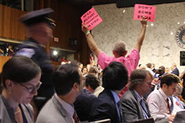 A Code Pink protester makes his opposition to U.S. military action against Syria known at the beginning of Tuesday's Senate Foreign Relations Committee.