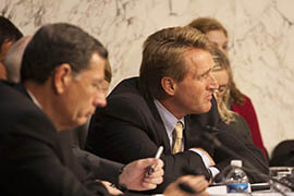Arizona Sen. Jeff Flake listens to other senators during the Senate Foreign Relations Committee meeting at which the committee voted to approved U.S. military strikes against Syria. Flake and Arizona Sen. John McCain both voted for military action.