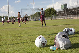 Mountain Ridge High School's varsity football team practices without pads. Aiming to reduce concussions, the Arizona Interscholastic Association allows teams to use only one-third of practice time for live contact during the regular season.