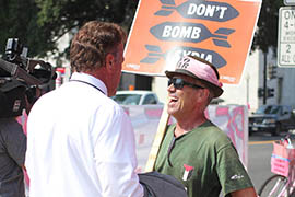 Code Pink protester Tighe Barry may be interviewed several times a day by reporters during demonstrations. Here he is outside the U.S. Capitol to oppose military action against Syria.