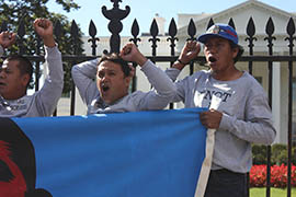 Tucson resident Narciso Valenzuela Siriaco, right, was one of a handful of protesters who handcuffed himself to the White House fence Wednesday to protest continued deportations.