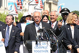 Rep. Ed Pastor, D-Phoenix, speaks at a rally for the merger of US Airways and the American Airlines. Pastor urged the Justice Department to back off the antitrust suit it filed in an effort to block the merger.