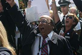 Vinod Rajpal, a US Airways worker from Washington Reagan National Airport, cheers at a Washington rally by employees of US Airways and American Airlines in support of their airlines' merger