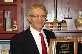 Douglas Rayes, left, receives the 2011 Judge of the Year Award from American Board of Trial Advocates Phoenix Chapter member Patrick J. McGroder III in December 2011.