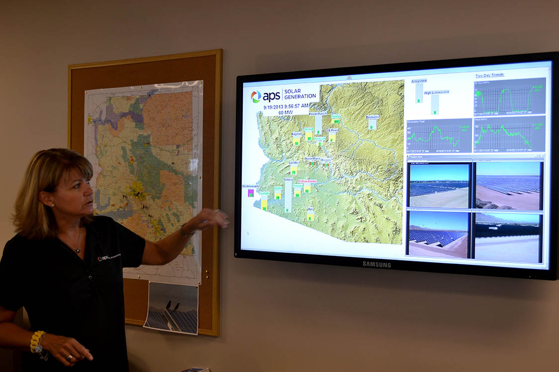 Barbara Lockwood, general manager of energy innovation for APS, shows screens that allow employees to monitor the operation of solar plants around Arizona.