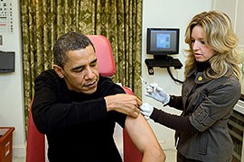 In this 2009 file photo, a White House nurse prepares to give President Barack Obama a flu vaccination.