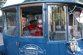 Mayor Greg Stanton rides in a 1915 electric vehicle belonging to APS.