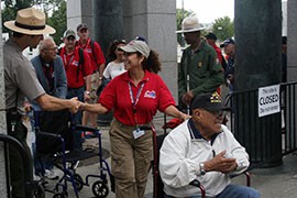 A volunteer with Honor Flight Southern Arizona thanks a National Parks Service ranger for opening the World War II Memorial for Arizona veterans Monday. The memorial is officially closed to visitors by the government shutdown.