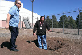 Kelvin Long, a Navajo who will serve as cultural adviser for a Native American religious program at the Coconino County Jail, and Jim Bret, program coordinator for detention services, look over the site of a fire pit that will be outside a sweat lodge planned for the jail. About half of the inmates are Native American.