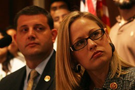 Rep. Kyrsten Sinema, D-Phoenix, listens during a news conference for a bill that she co-sponsored, which would make it possible to undocumented immigrants in this country to join the military.