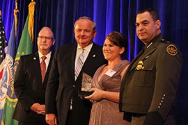 Samantha Hope poses with, from left, Border Patrol Foundation President Ron Colburn, acting Customs and Border Protection Commissioner Thomas J. Winkowski and Border Patrol Chief Michael J. Fisher, after receiving an award from the foundation.