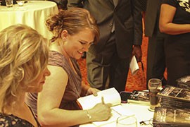 Samantha Hope signs a copy of her book 