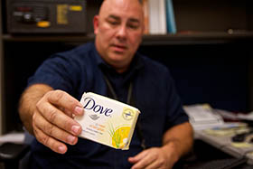 Detective Sgt. David Lake displays a bar of soap that was stolen en route from Turkey to Russia and wound up a store shelf in Phoenix. Lake heads the Phoenix Police Department's Business and Economic Stability (BEST) project.