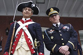 Staff Sgt. Enrique Garcia, left, and 1st Lt. Tyler O'Connor pose in their colonial and modern uniforms, in front of Alpha Company's office at Fort Myer in Arlington, Va.