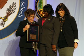Chandler Traditional Academy-Liberty Campus Principal Beth Ann Bader, left, and teacher Christine Rabe, right, pose with Aba Kumi, director of the National Blue Ribbon Schools Program.
