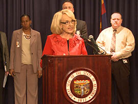 Gov. Jan Brewer addresses a news conference Monday at which she announced an eight-member panel to provide independent oversight of Child Protective Services' review of 6,000 cases that went uninvestigated.