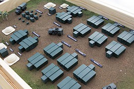 A mock-up shows how the expandable rigid-wall shelters could be deployed to create a 150-man base camp with housing, showers, dining facilities and an operations center.