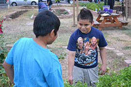 Caesar Tapia, at right, one of the garden’s youth program members, said he and others enjoy the education and transition to healthier eating.