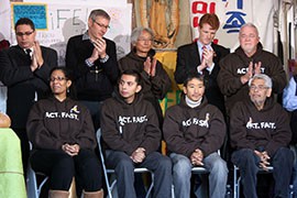 The four hunger strikers, seated, include Arizona resident Cristian Avila, second from left. They gave up their fast after 22 days and will be replaced by seven new protesters standing behind them, including Rep. Joe Kennedy, D-Mass., in the red tie.