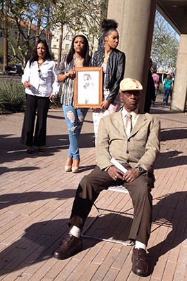 Bishop Henry Barnwell, foreground, attends a news conference calling on Arizona State University to take action against a fraternity that held an 