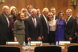 Douglas Reyes, in blue tie, poses with family and friends after the Senate Judiciary Committee heard his nomination to a U.S. District Court judgeship in Arizona.