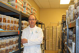 Dr. Thomas Beach, director of Banner Sun Health’s Brain and Body Donation Program, stands in front of containers used to store human tissues removed from donors for study.