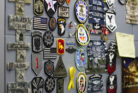 A wall inside the Veterans Services Center at Glendale Community College displays the patches of current and former students.
