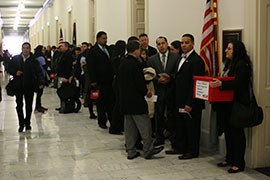 Advocates and members of the National Council of La Raza line a Capitol hallway for the mock election in support of immigration reform organized by La Raza. A reform measure passed the Senate last summer but the effort is stalled in the House