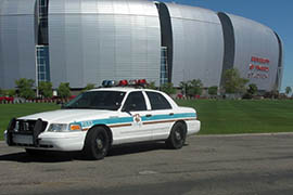 A police car is parked in front of University of Phoenix Stadium in Glendale, home of the 2015 Super Bowl.