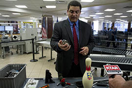 Nico Melendez, a spokesman for the Transportation Security Administration, shows a lighter that looks like a hand grenade. It's one of the items confiscated during the past week at Phoenix Sky Harbor International Airport's checkpoints.