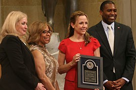 Jamie Balson holds a Justice Department award with, from left, Joye Frost, director of the Office for Victims of Crime, Assistant Attorney General of the Office of Justice Programs Karol Mason and Associate Attorney General Tony West.