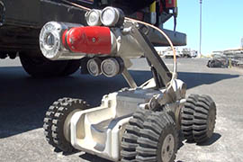 SRP's 70-pound, steel robot has wheel and axle configurations for different widths of pipe and features LED lighting around its camera. More than 1,000 feet of cable allows it to move around freely in pipes.