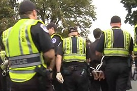 A not-uncommon sight in Washington: Police calmly lead off a protester in zip cuffs after one of many demonstrations in the city. Protesters often want to get arrested, while police have to balance free speech with security.