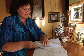 Carla Perez with some of the paperwork from her family's pursuit of health care after her daughter was dropped from the state's KidsCare II program