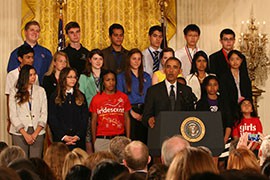 Phoenix teens Diserae Sanders - front row, left - and Martin Carranza and Quenan Ruiz - back row, center - listen as President Barack Obama announces new science education initiatives during the White House Science Fair.