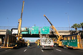 Crews work on replacing signs on Interstate 10 at the 12th Street overpass in Phoenix. State officials are not worried about a disruption to road projects, despite a shaky outlook for the federal transportation trust fund.