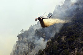 A helicopter battling the Slide Fire in Coconino National Forest in May. The blaze cost $10.2 million to contain as it burned more than 20,000 acres before it was contained.
