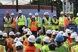 Workers gather at a stand-down event to learn about fall safety this week at the site of the National Museum of African American History Culture, which is under construction in Washington.