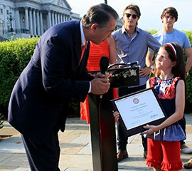 Rep. Trent Franks, R-Glendale, presents a certificate to Mia Robertson, 10, for the work she and her family - the subjects of the reality show 