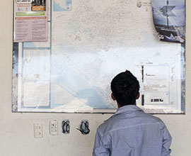 Elisman Hernandez studies a map of Mexico on the wall at the House of Mercy migrant shelter in the southern Mexican state of Chiapas.