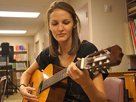 Anna Philipe, a senior in ASU's music program, practices a song on the guitar.
