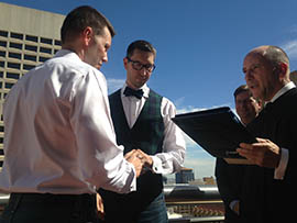 Timothy Allen Pawlak, left, marries Jason Grant Bannecker before Phoenix Municipal Court Judge Kevin Kane on Friday, just hours after a federal judge overturned the state's ban on same-sex marriage. Phoenix Mayor Greg Stanton looks on.