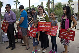 Supporters rallied outside Thursday as members of the group Why Marriage Matters delivered petitions urging Attorney General Tom Horne to stop defending Arizona's ban on same-sex marriage.