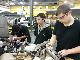Matthew Capota, center, works students in the aviation program at Western Maricopa Education Center (West-MEC), one of the 13 joint technical education districts in Arizona.