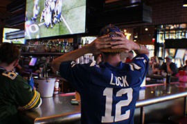 Indianapolis fan Christopher Ryan Savoie shakes his head in disbelief after another Colts turnover during the AFC Championship Game against the New England Patriots.